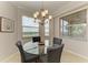 Bright dining area with glass table and chandelier at 8105 Grand Estuary Trl # 307, Bradenton, FL 34212