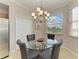 Dining area with glass table, chandelier, and window views at 8105 Grand Estuary Trl # 307, Bradenton, FL 34212