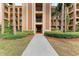 Condo building entry with walkway and landscaping at 8105 Grand Estuary Trl # 307, Bradenton, FL 34212