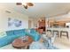 Spacious living room with teal sectional sofa and adjacent kitchen at 8105 Grand Estuary Trl # 307, Bradenton, FL 34212