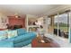 Condo living room with teal sectional sofa and kitchen view at 8105 Grand Estuary Trl # 307, Bradenton, FL 34212