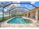 Relaxing pool and spa with screened enclosure and water views at 8790 Wild Dunes Dr, Sarasota, FL 34241