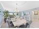 Bright dining area with white table and gray chairs, and a view to the living room at 1125 Edgewater Cir # 13 Sec 1, Bradenton, FL 34209