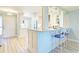 Modern kitchen with white cabinets, stainless steel appliances and breakfast bar at 1125 Edgewater Cir # 13 Sec 1, Bradenton, FL 34209