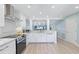 Modern white kitchen with stainless steel appliances and granite countertops at 1125 Edgewater Cir # 13 Sec 1, Bradenton, FL 34209