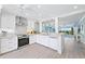 Modern white kitchen features stainless steel appliances and light wood flooring at 1125 Edgewater Cir # 13 Sec 1, Bradenton, FL 34209