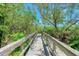 Wooden boardwalk pathway through lush natural landscape at 1125 Edgewater Cir # 13 Sec 1, Bradenton, FL 34209