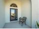 Front entry with dark door and small sitting area at 11422 Griffith Park Ter, Bradenton, FL 34211