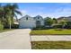 White house with gray roof, two-car garage, and well-manicured lawn at 11422 Griffith Park Ter, Bradenton, FL 34211