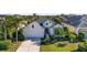 White house with gray roof, two-car garage, and lush landscaping at 11422 Griffith Park Ter, Bradenton, FL 34211