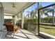 Relaxing screened porch with wicker furniture, ceiling fan, and view of backyard at 11422 Griffith Park Ter, Bradenton, FL 34211