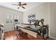 Bright sewing room featuring a long quilting table and hardwood floors at 11422 Griffith Park Ter, Bradenton, FL 34211