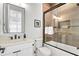 Modern bathroom with a walk-in shower, floating vanity, and neutral tones at 171 Mckinley Dr, Sarasota, FL 34236