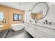 Spa-like bathroom with soaking tub, double vanity, and modern fixtures at 171 Mckinley Dr, Sarasota, FL 34236