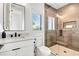 Clean bathroom with white vanity, glass shower, and neutral tile at 171 Mckinley Dr, Sarasota, FL 34236