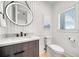Small bathroom with toilet, sink, and modern vanity at 171 Mckinley Dr, Sarasota, FL 34236