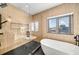 Bathroom with walk-in shower, freestanding tub, and wood-like tile at 171 Mckinley Dr, Sarasota, FL 34236