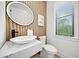 Elegant powder room featuring a vessel sink and wood-paneled wall at 171 Mckinley Dr, Sarasota, FL 34236