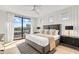 Bright bedroom with king-size bed, balcony access, and stylish decor at 171 Mckinley Dr, Sarasota, FL 34236
