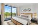 Bright bedroom with king-size bed and sliding glass doors leading to a deck at 171 Mckinley Dr, Sarasota, FL 34236