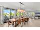 Elegant dining room with large wooden table, and access to balcony overlooking water at 171 Mckinley Dr, Sarasota, FL 34236