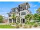 Two-story home with two-car garage, spiral staircase, and landscaped yard at 171 Mckinley Dr, Sarasota, FL 34236