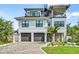 Three-story house with two-car garage, spiral staircase, and landscaped yard at 171 Mckinley Dr, Sarasota, FL 34236
