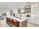 Modern kitchen with white cabinets, large island, and marble countertops at 171 Mckinley Dr, Sarasota, FL 34236