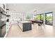Modern kitchen with white cabinets, island, and dining area at 171 Mckinley Dr, Sarasota, FL 34236