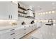 Modern white kitchen with marble countertops and high-end appliances at 171 Mckinley Dr, Sarasota, FL 34236