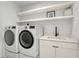 Convenient laundry room with washer, dryer, and extra shelving at 171 Mckinley Dr, Sarasota, FL 34236