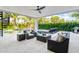 Relaxing patio area adjacent to the pool and surrounded by lush landscaping at 171 Mckinley Dr, Sarasota, FL 34236