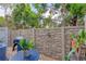 Landscaped backyard with stone wall and plants at 204 Crew Ct, Sarasota, FL 34243