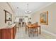 Bright dining room features a wooden table with chairs and built-in hutch at 204 Crew Ct, Sarasota, FL 34243