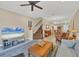 Living room with hardwood floors, a large TV, and staircase at 204 Crew Ct, Sarasota, FL 34243
