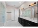 Elegant bathroom with double vanity, large mirror, and walk-in shower at 311 Compass Point Dr # 201, Bradenton, FL 34209