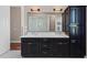 Bathroom boasts double sinks, dark cabinetry, and ample storage at 311 Compass Point Dr # 201, Bradenton, FL 34209