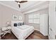 Bright bedroom with a queen-size bed, hardwood floors, and a ceiling fan at 311 Compass Point Dr # 201, Bradenton, FL 34209
