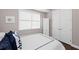 Comfortable bedroom featuring a bed, window with blinds, and ample closet space at 311 Compass Point Dr # 201, Bradenton, FL 34209