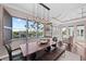 Bright dining room with water views and a modern light fixture at 311 Compass Point Dr # 201, Bradenton, FL 34209