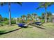 Peaceful hammock area with two comfortable hammocks under palm trees at 311 Compass Point Dr # 201, Bradenton, FL 34209