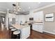Bright kitchen featuring white cabinets, granite countertops, and breakfast bar at 311 Compass Point Dr # 201, Bradenton, FL 34209