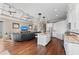 Open concept kitchen with island, stainless steel appliances, and hardwood floors at 311 Compass Point Dr # 201, Bradenton, FL 34209