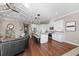 Open kitchen with white cabinets, granite island, and hardwood floors at 311 Compass Point Dr # 201, Bradenton, FL 34209