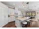 Modern kitchen with white cabinets, granite countertops, and island seating at 311 Compass Point Dr # 201, Bradenton, FL 34209