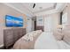 Bright main bedroom with large TV and dresser at 311 Compass Point Dr # 201, Bradenton, FL 34209