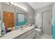 Updated bathroom with a teal color scheme and a large mirror at 339 Rio De Janeiro Ave, Punta Gorda, FL 33983