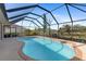Relaxing kidney-shaped pool with a screened enclosure at 339 Rio De Janeiro Ave, Punta Gorda, FL 33983