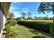 Landscaped backyard offering a tranquil view of a golf course at 3416 W Chelmsford Ct # 2, Sarasota, FL 34235
