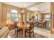 Elegant dining room with a wooden table and mirrored wall reflecting the kitchen at 3416 W Chelmsford Ct # 2, Sarasota, FL 34235